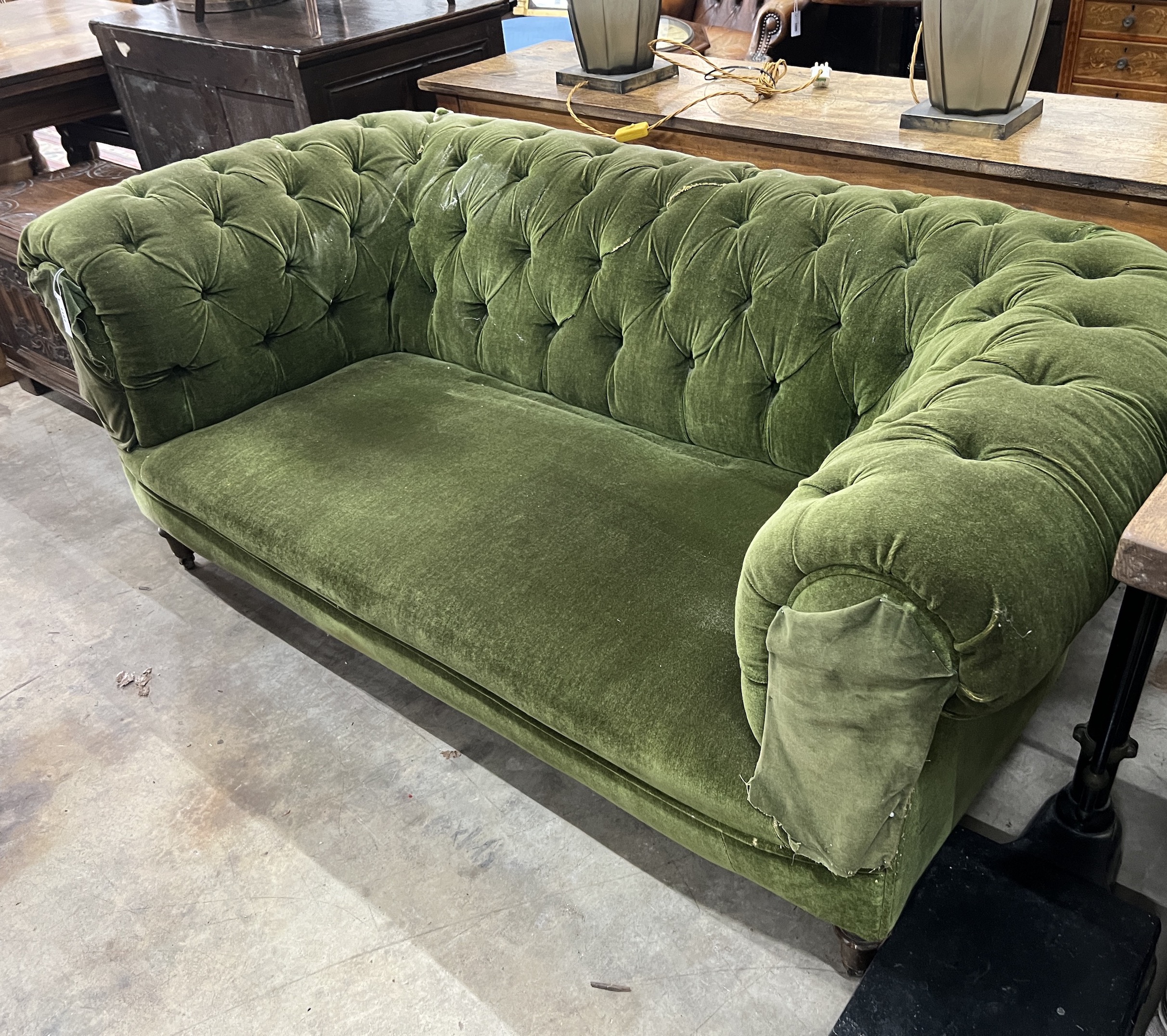 A late Victorian Chesterfield settee upholstered in buttoned green fabric, length 180cm, width 90cm, height 72cm